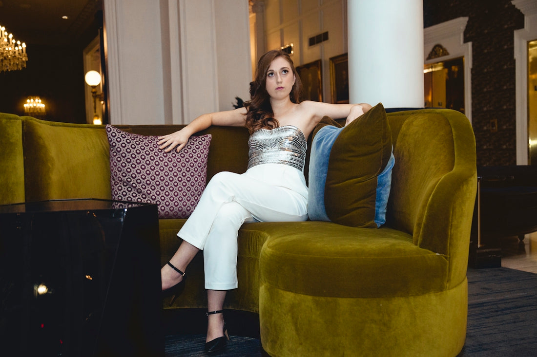 woman in white dress lying on couch