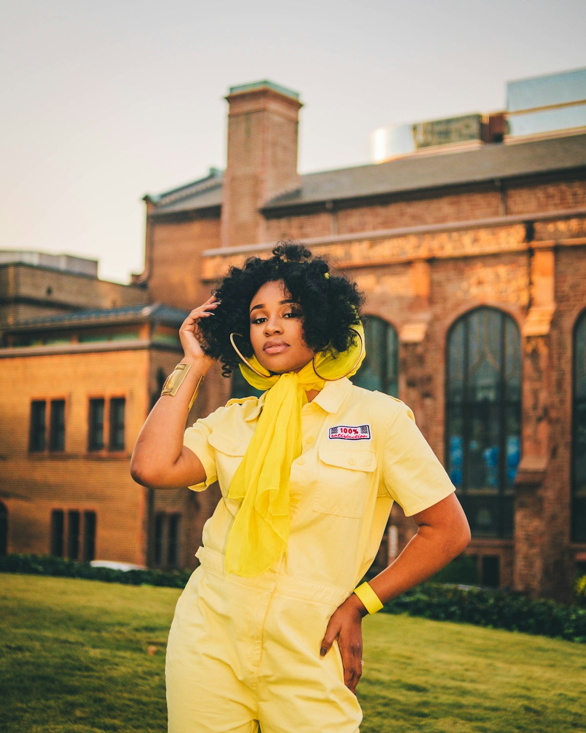 woman in yellow button up shirt standing on green grass field during daytime