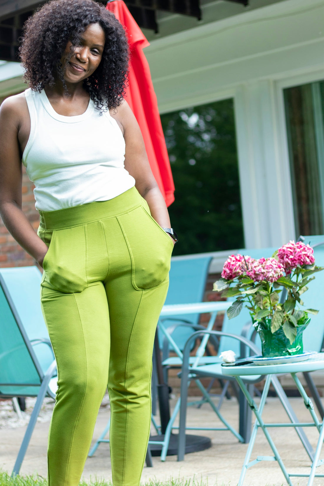 woman in white tank top and yellow pants