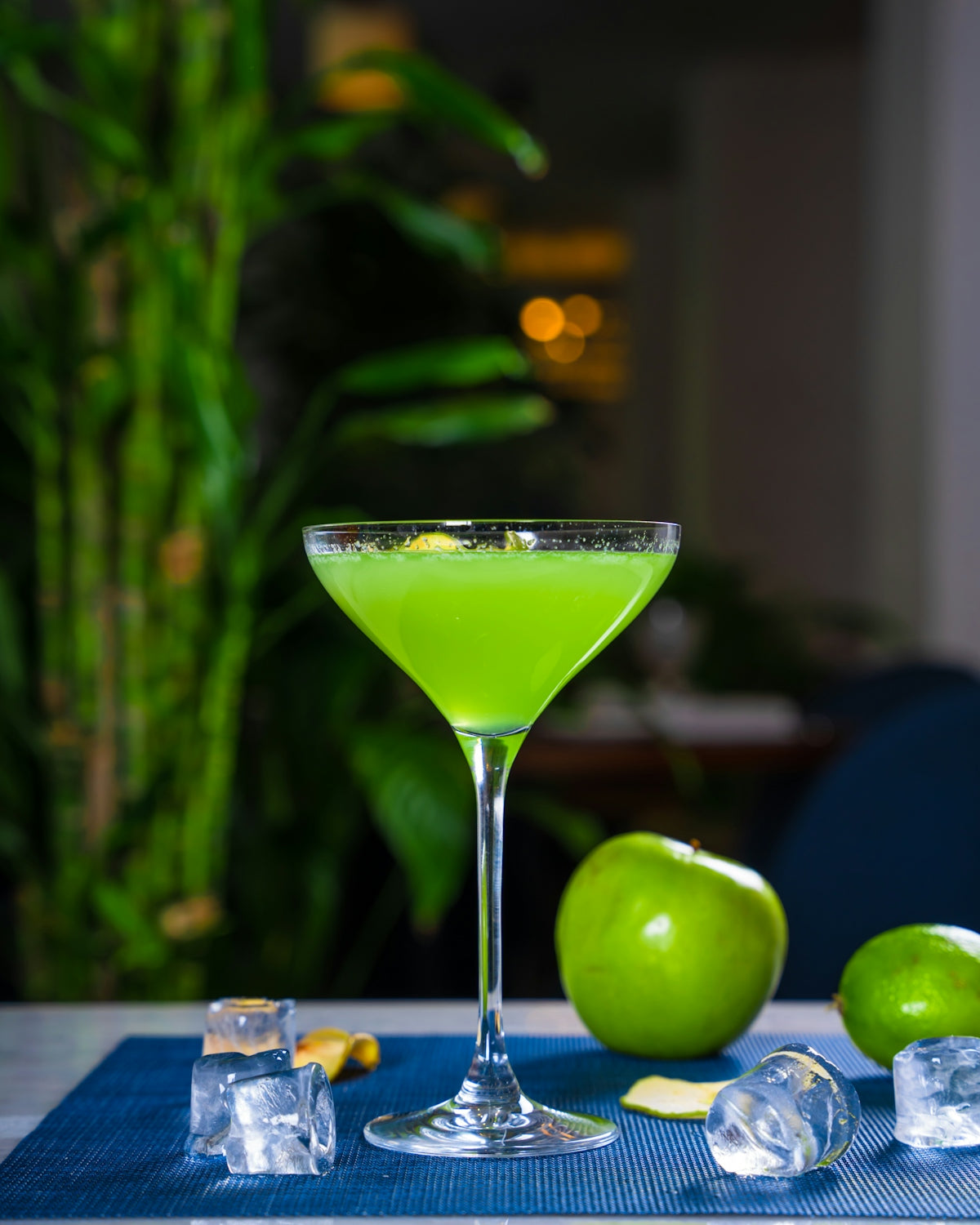 a green drink sitting on top of a table