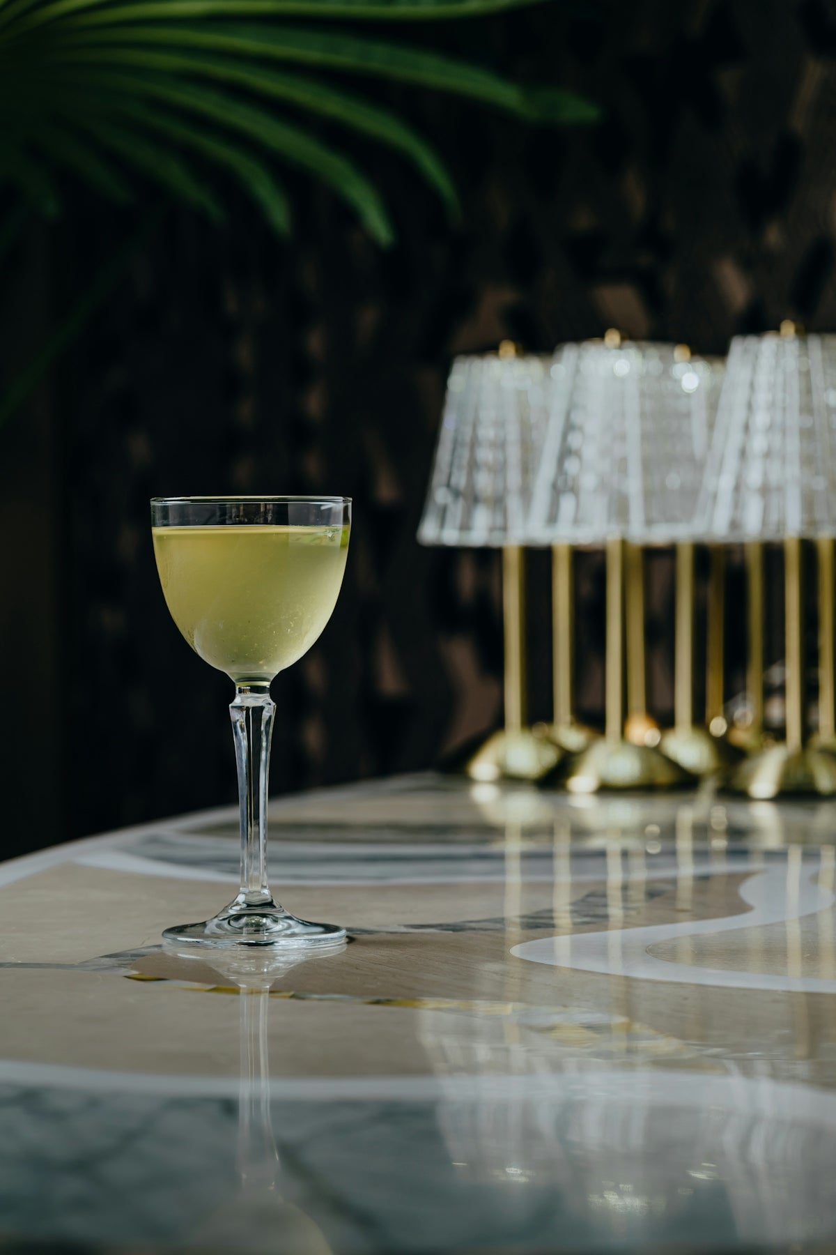 a glass of wine sitting on top of a table