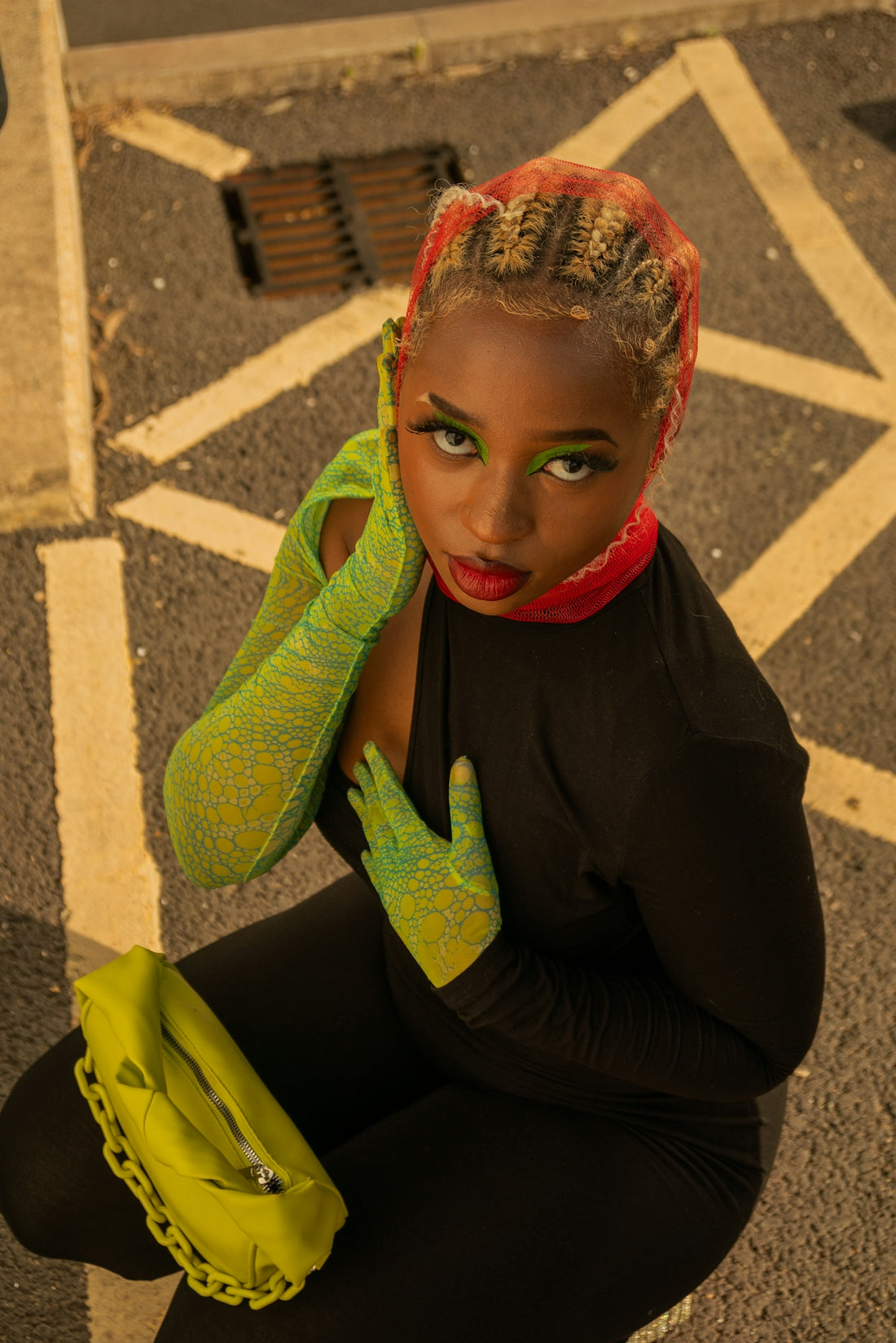a woman sitting on the ground with her hands on her head