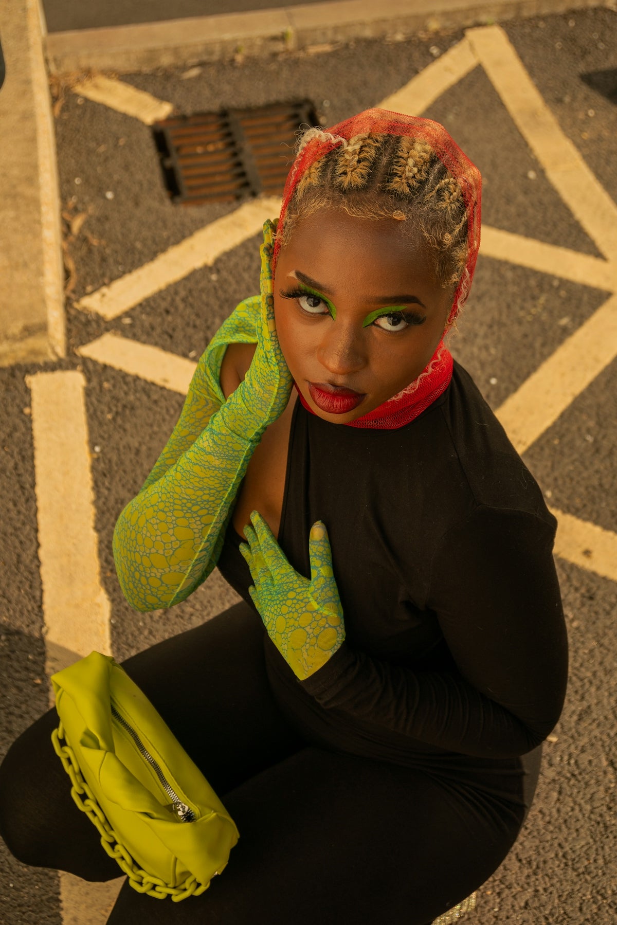 a woman sitting on the ground with her hands on her head