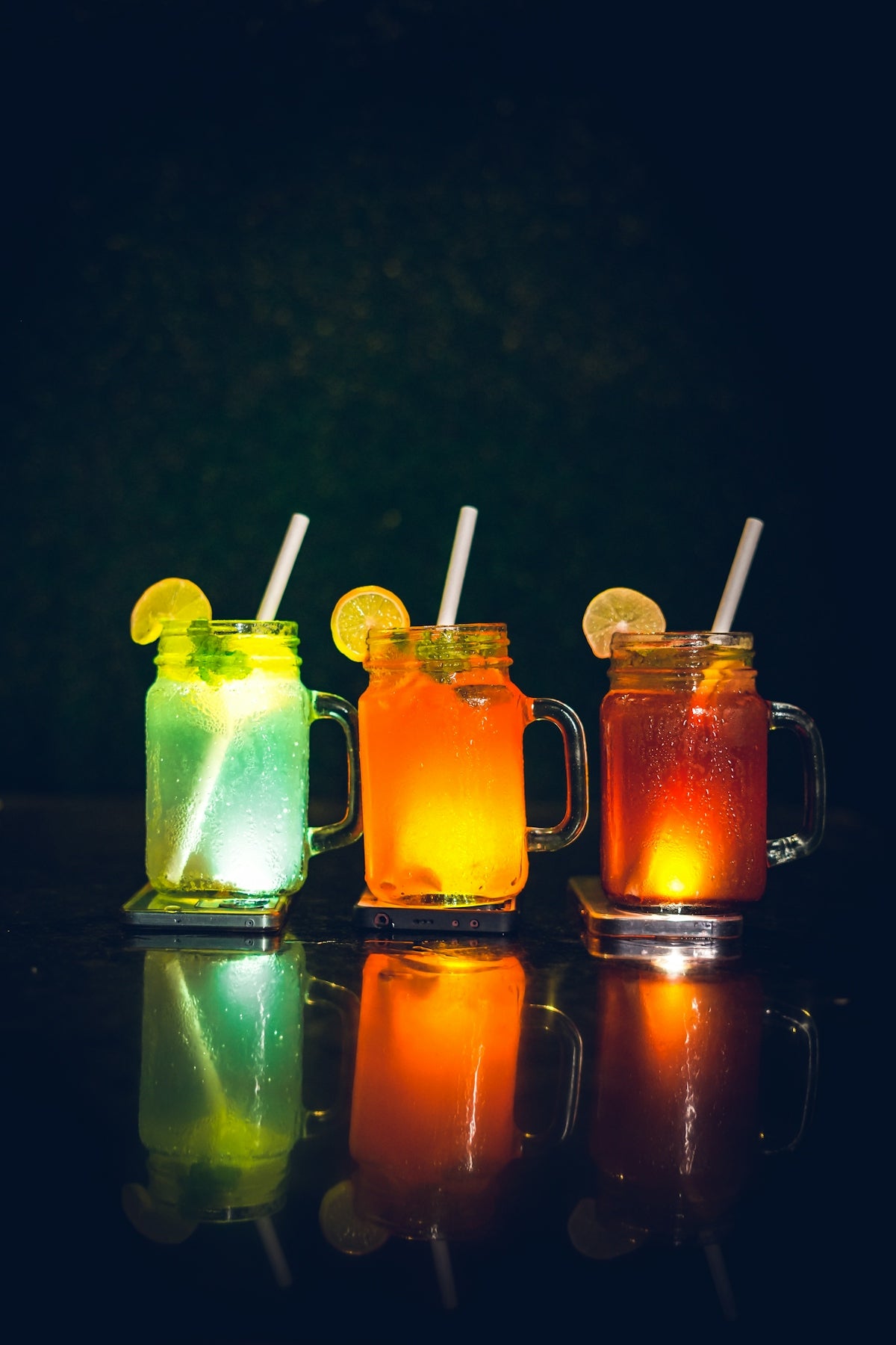 three mugs with drinks in them sitting on a table
