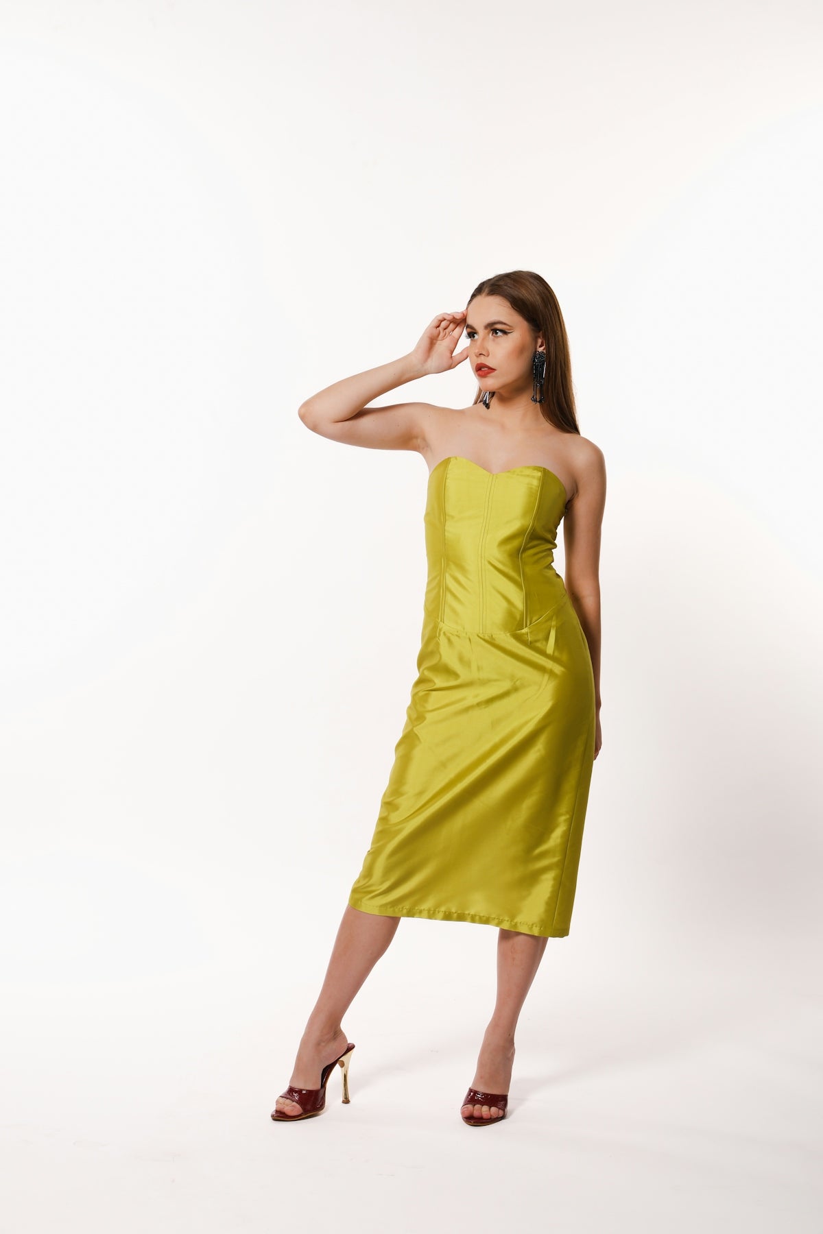 A woman in a yellow dress posing for a picture