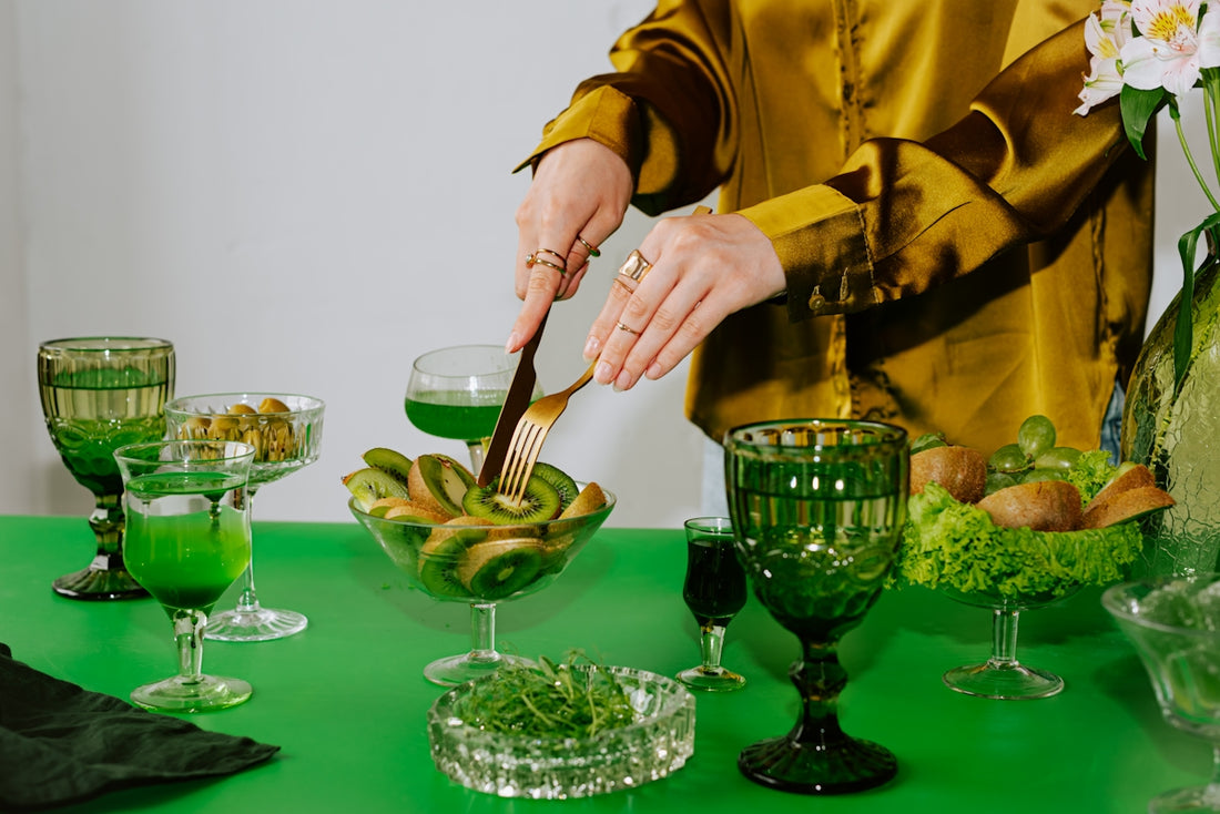 A woman standing at a table with a green table cloth