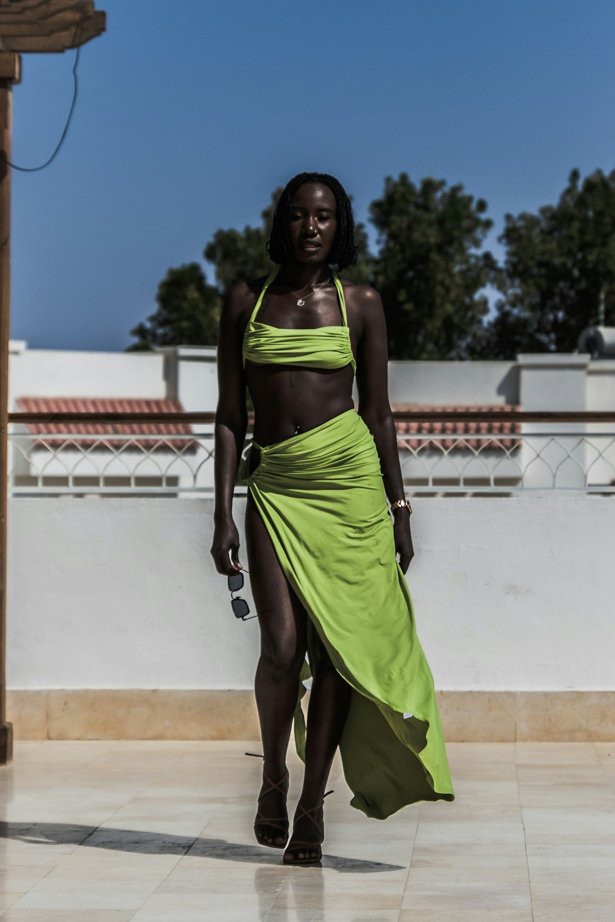 A woman in a bikini top and a skirt