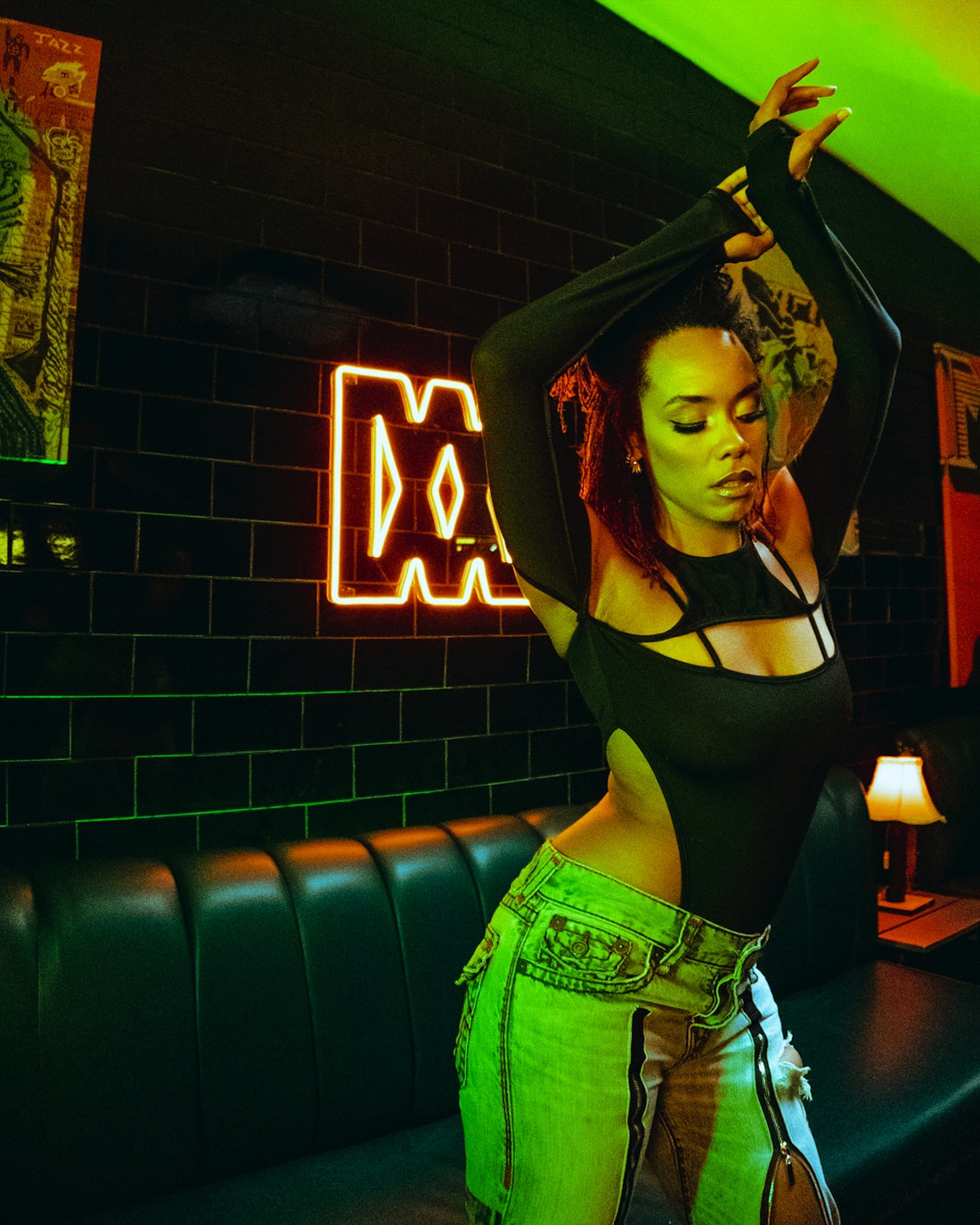 A woman standing in a room with neon lights