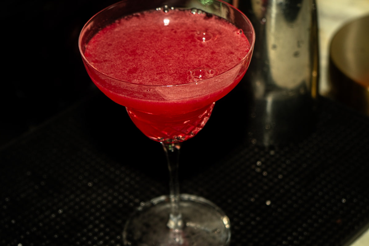 A vibrant, ruby-red cocktail awaits.
