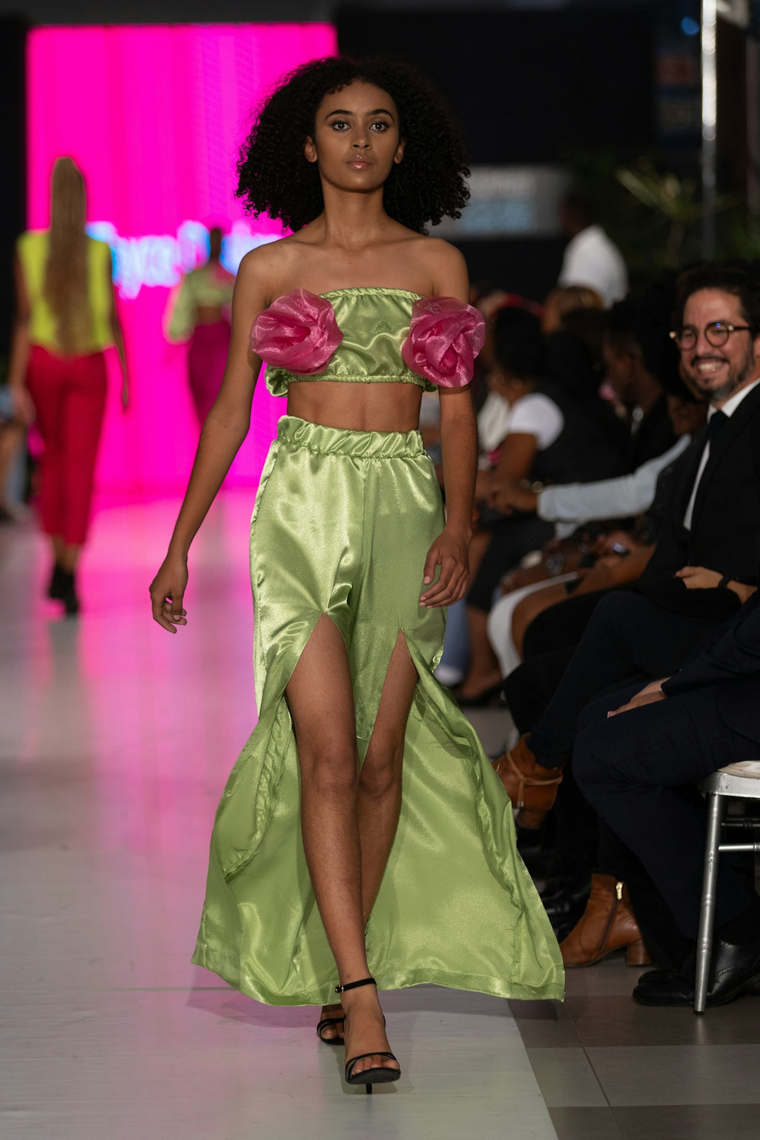 A model walks the runway in stylish attire.