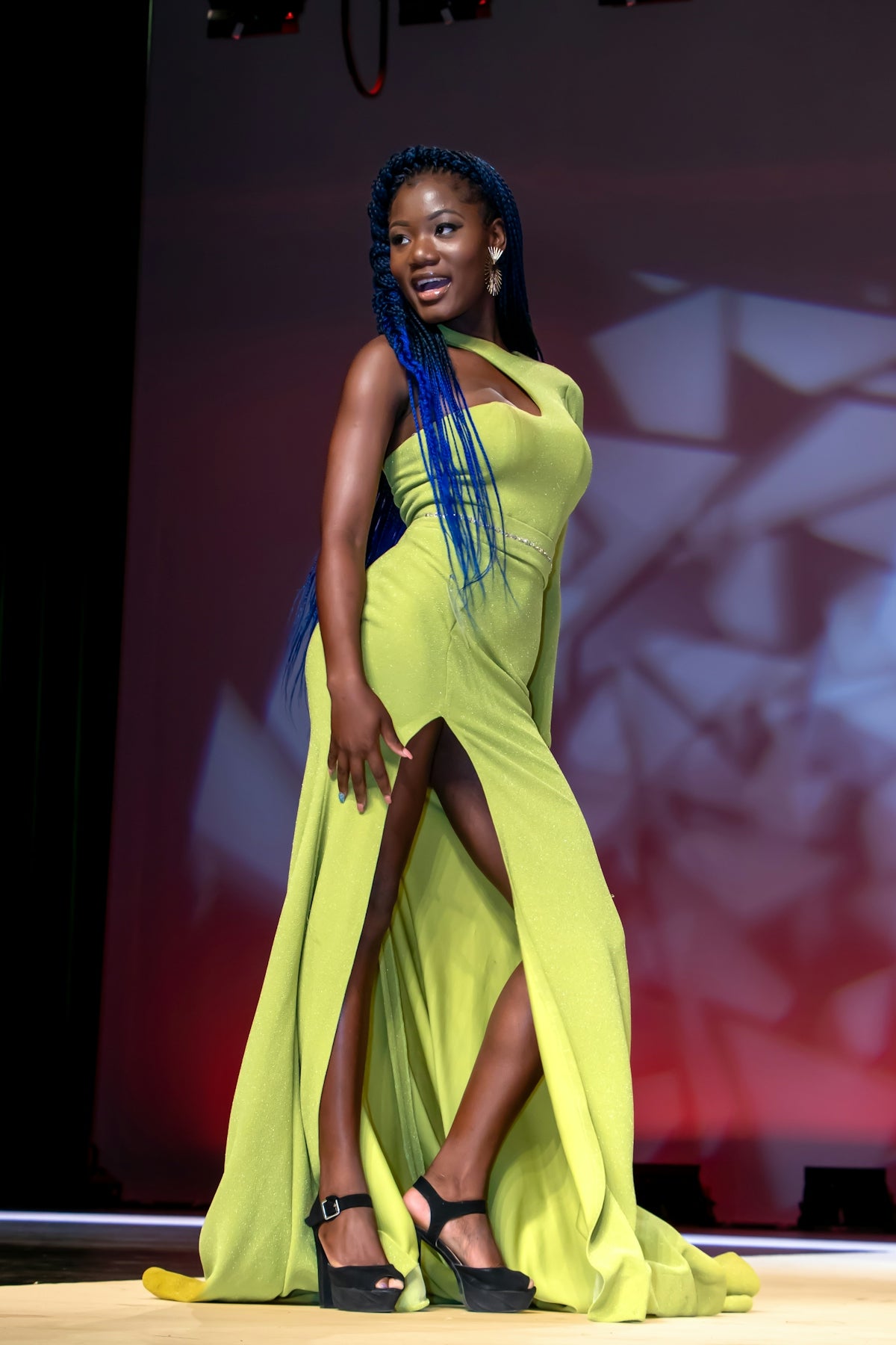 A woman poses in an elegant green dress